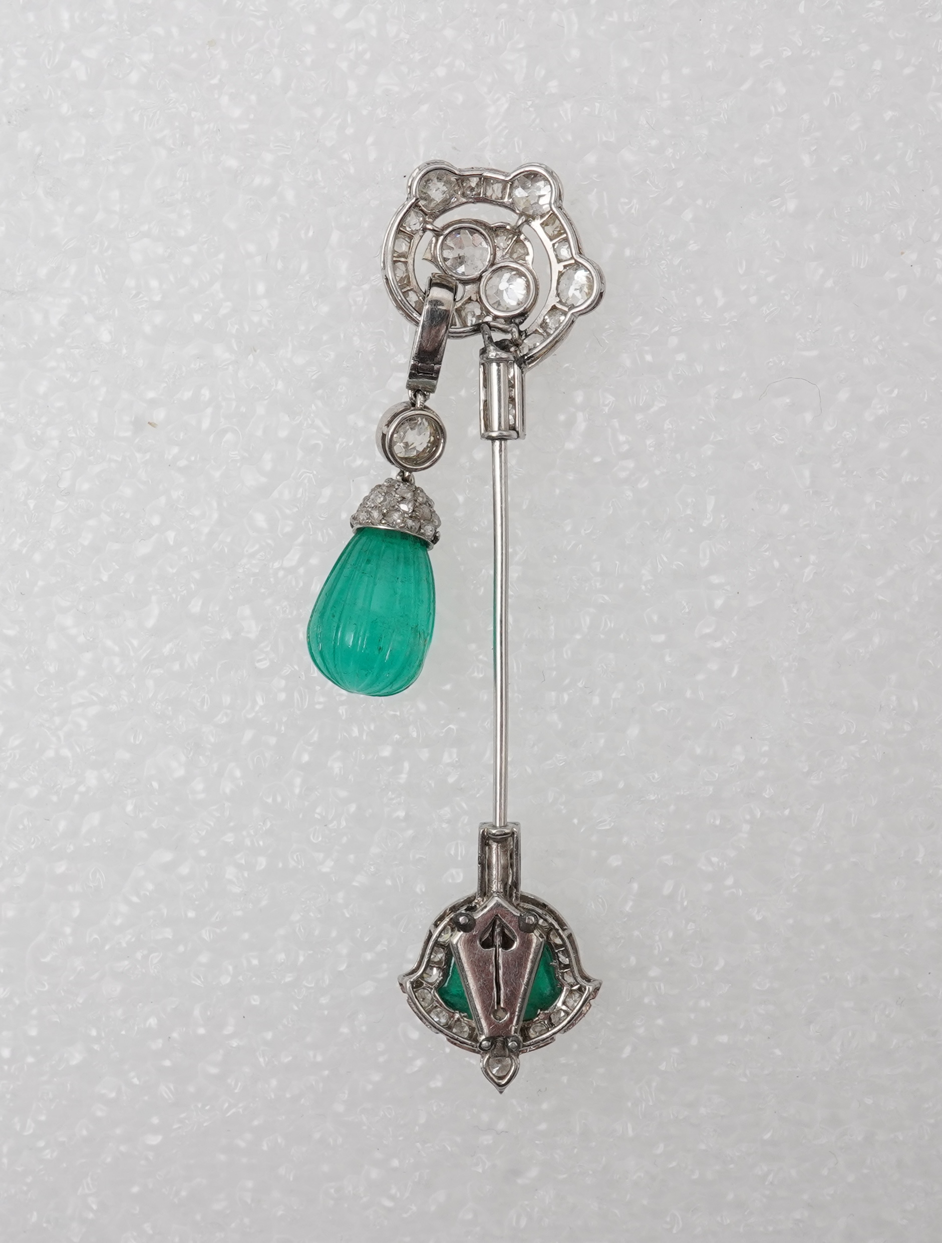 A fine Art Deco carved emerald and diamond jabot pin, circa 1925